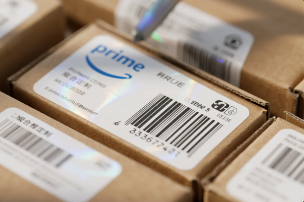 The image features a close-up shot of several small brown cardboard boxes, each with a white product label that includes the "prime" logo, product information, and barcodes. The labels also display quality certification marks and a mix of English and Chinese text, emphasizing the brand's attention to detail and traceability in packaging. The boxes are neatly stacked, reflecting a professional and organized logistics or shipping environment.