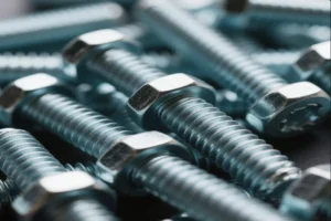 Close-up of several metal bolts with threaded shafts and hexagonal heads, showcasing their precision and durability.