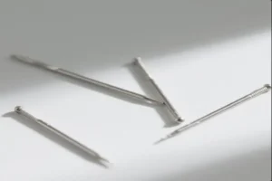 Close-up of metal needles, showcasing fine details of CNC machining and precision threading.