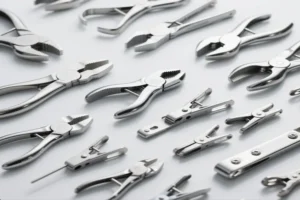 A collection of high-precision industrial pliers and clamps, showcasing a variety of tools designed for secure gripping and manipulation in manufacturing.