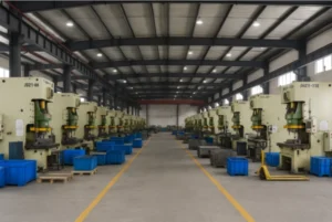 Metal stamping press line in a large factory workshop with multiple press machines, organized workstations, and clear safety aisle markings for mass production.