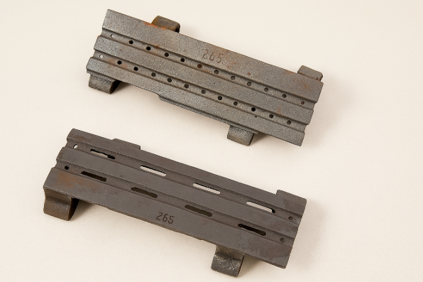 Heat-resistant chain grate bars cast in metal with slot and hole patterns for industrial furnace systems