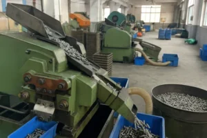 Industrial machine manufacturing and sorting custom metal fasteners in a factory