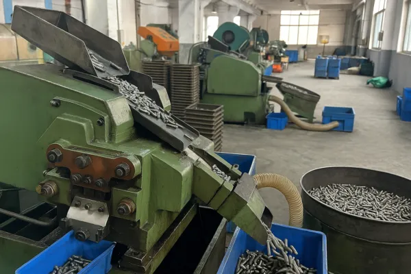 Industrial machine manufacturing and sorting custom metal fasteners in a factory